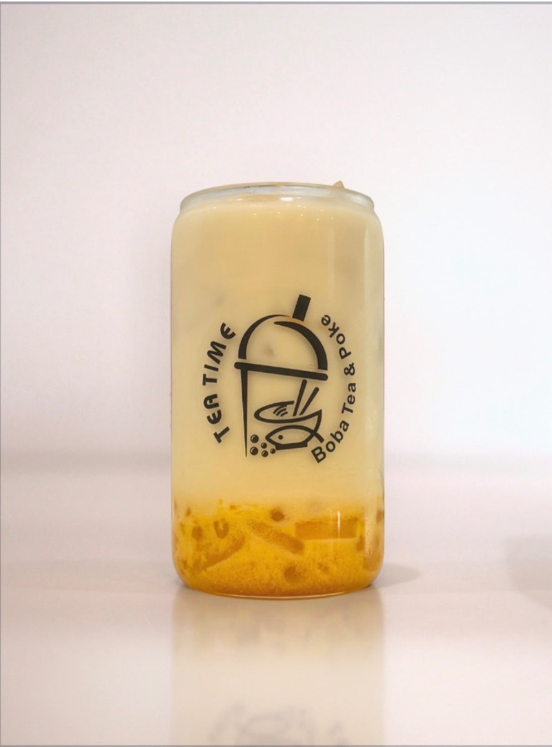 Triple mango green milk tea in a Tea Time glass